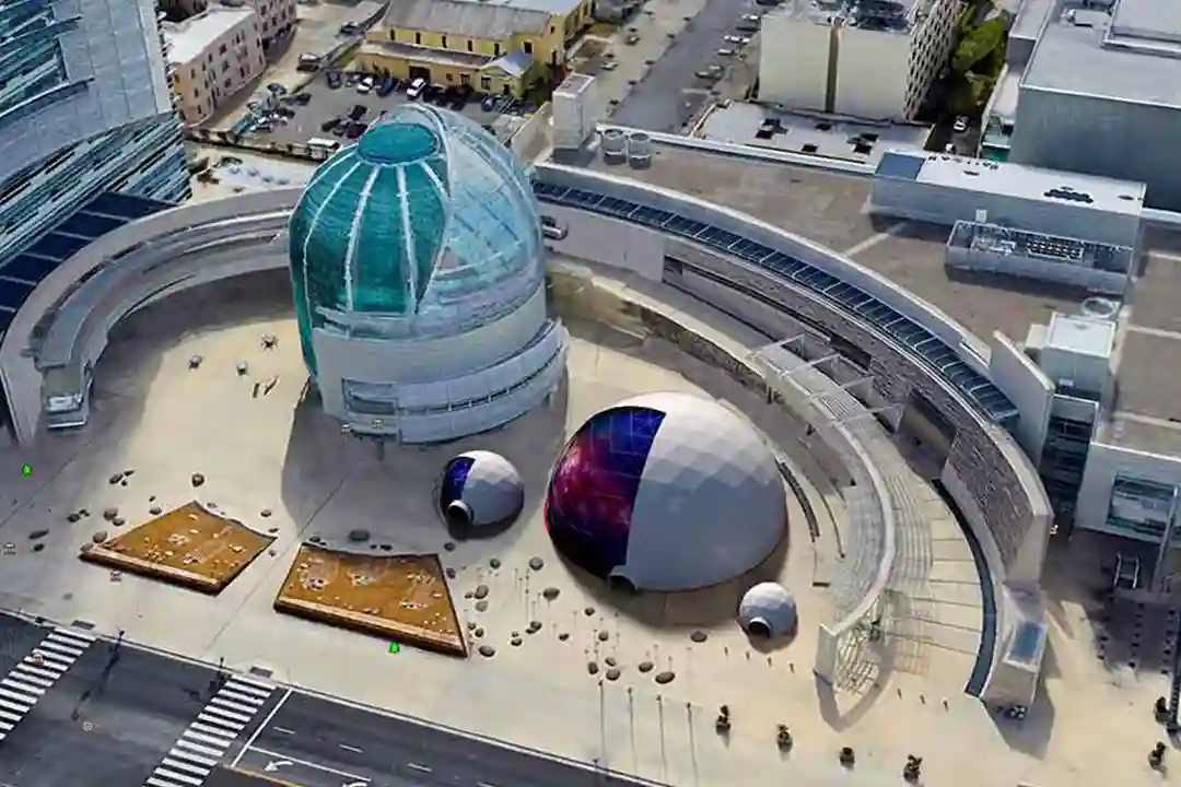 3D rendering of geodesic domes composited into a Google Earth aerial image of a plaza beside a glass-domed building