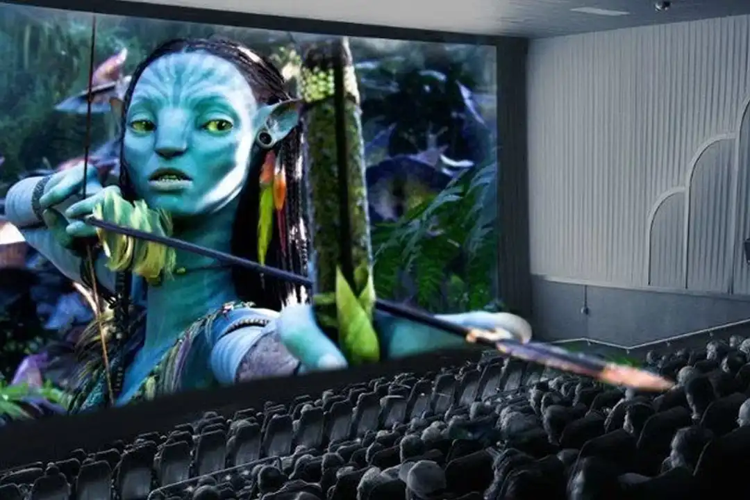 Visualization of Avatar in IMAX 3D, a blue character drawing a bow that appears to extend out of the screen over the seats