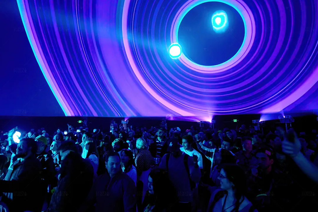Crowd under blue and purple concentric ring visuals projected on a dome at South by Southwest in Austin
