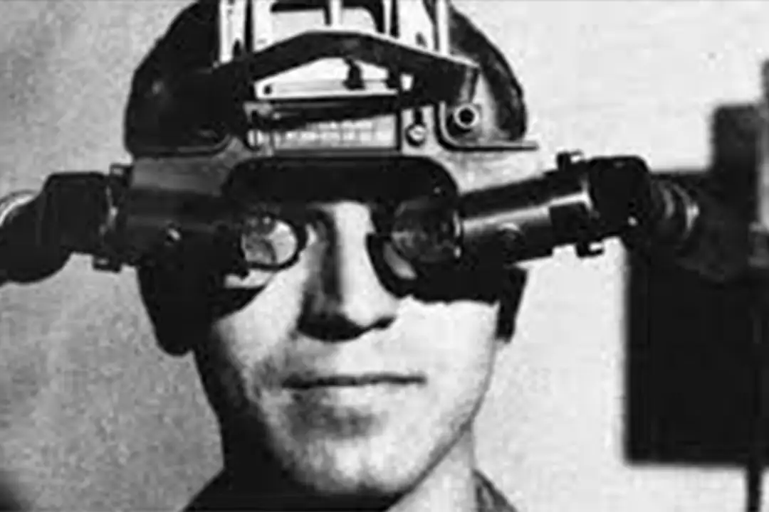Man wearing a bulky early head-mounted display in a black-and-white photo illustrating Ivan Sutherland's Ultimate Display