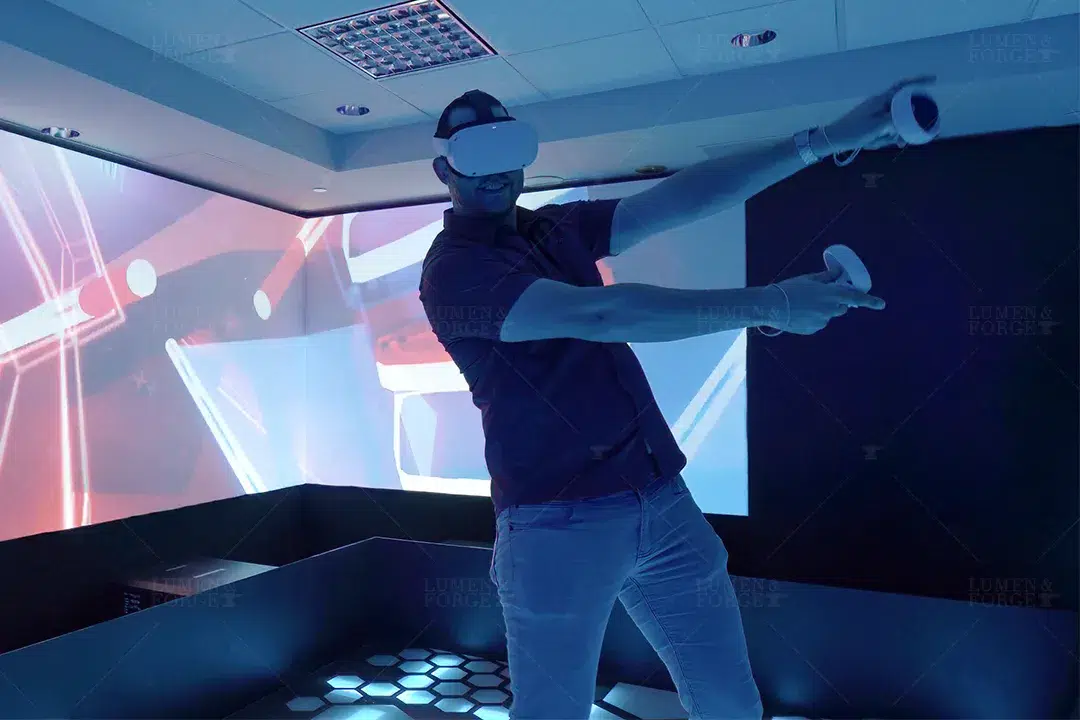 Man in a VR headset swinging controllers in a room with projected walls at the Meta Latin Grammys activation