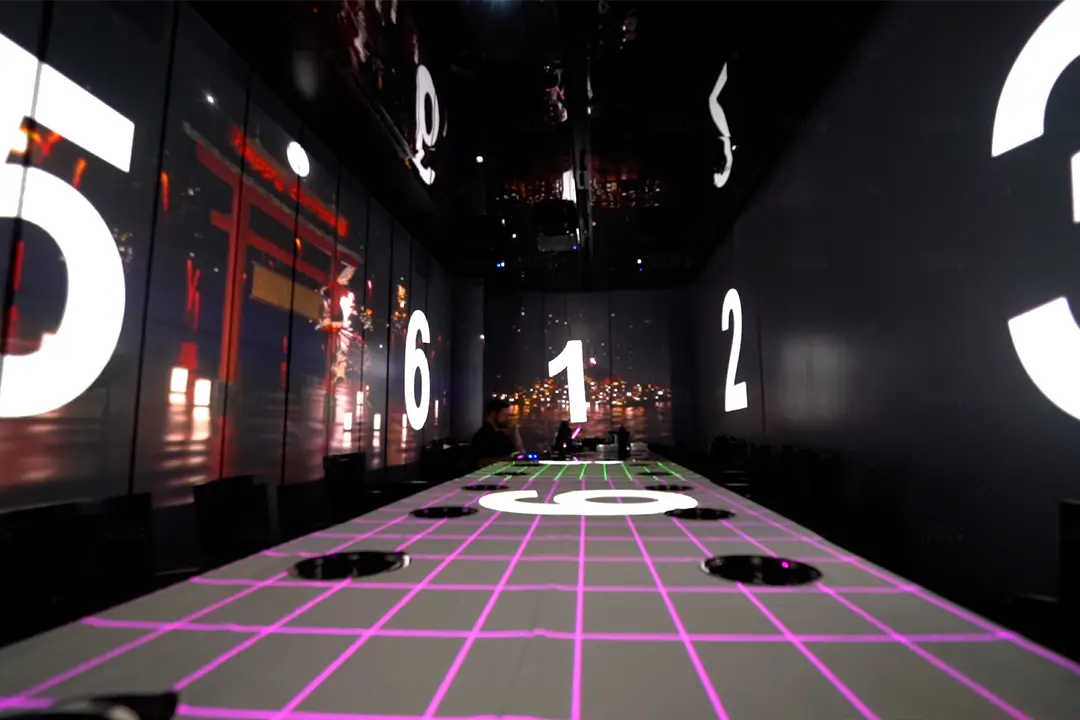 The X Pot dining room with large numbers projected on the walls and a pink grid mapped onto the long table