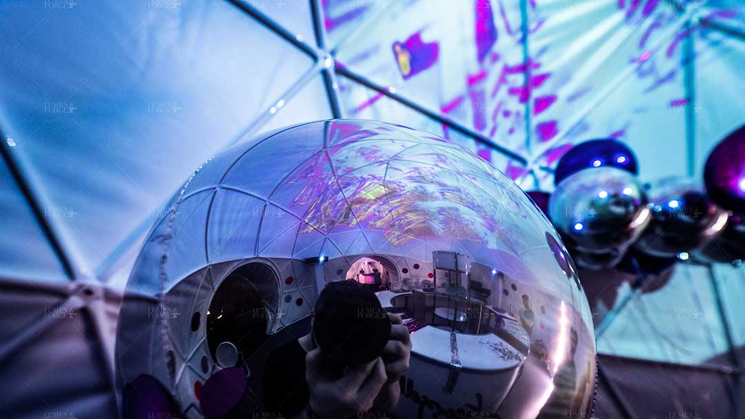 Closeup of photographer's reflection on a balloon inside the Big Sur event dome