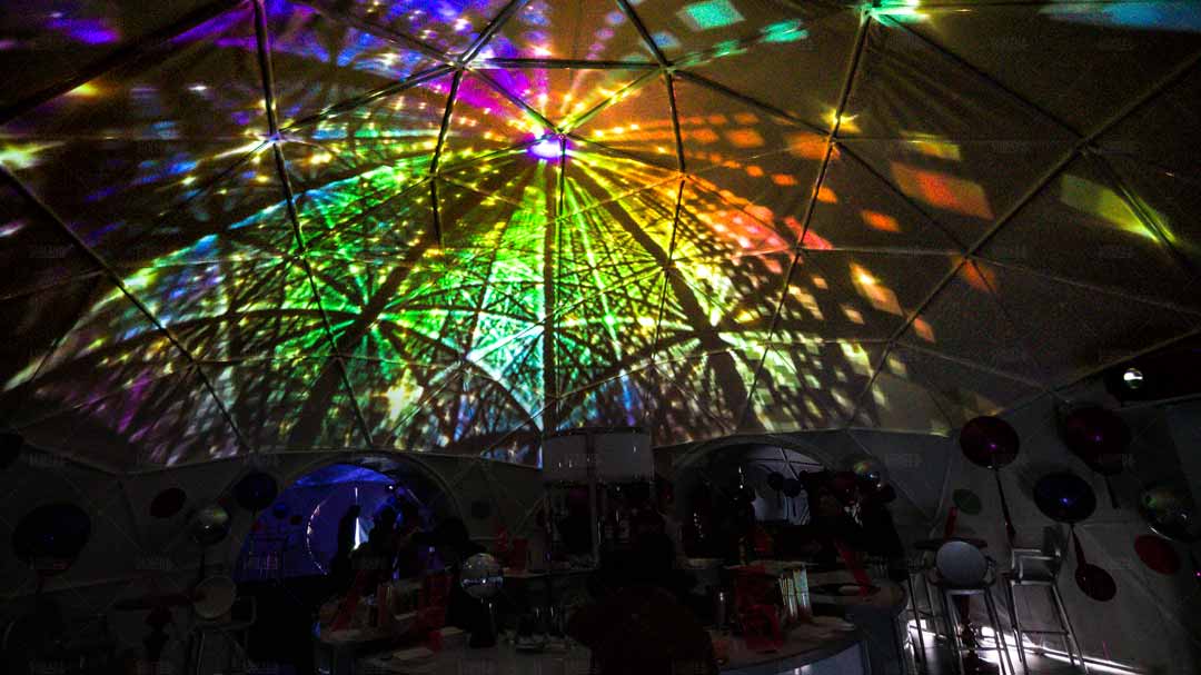 Interior of Big Sur event dome with geometric content projected inside dome