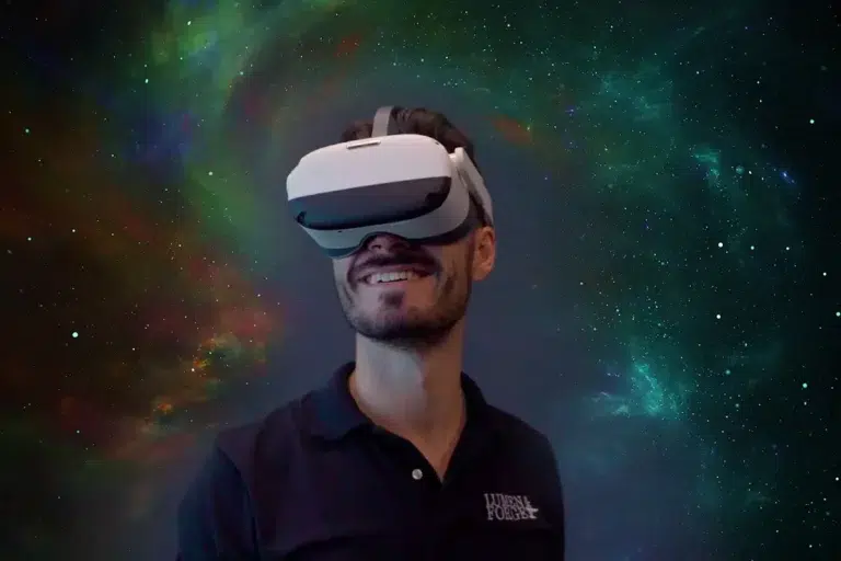 man wearing vr goggles looking happy with galaxy background learning about the history of virtual reality