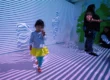 little girl walking through 3D interactive immersive room