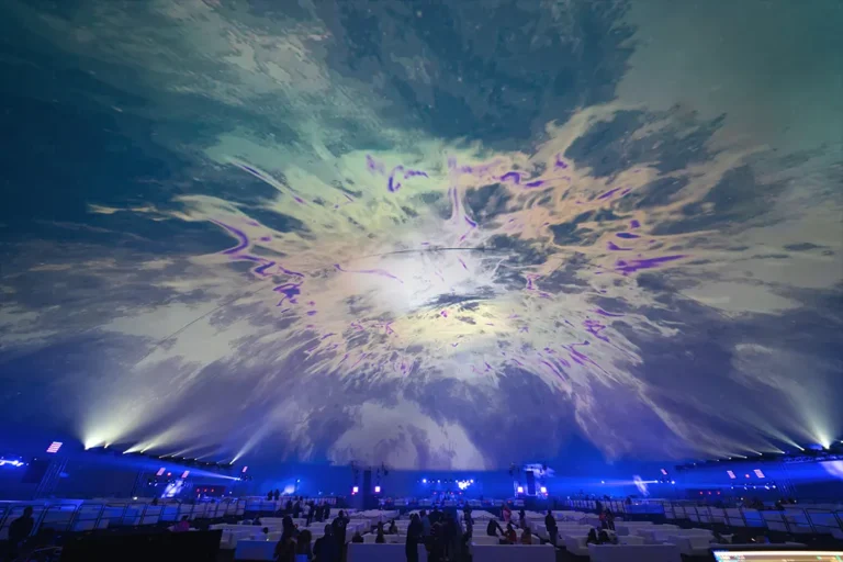 Immersive 360-degree visuals projected onto the world's largest planetarium dome, featuring vibrant pink and blue geometric patterns
