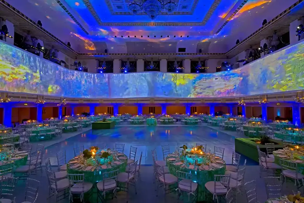 Immersive 360-degree projection mapping for an elegant wedding reception with vibrant visuals on the walls and ceiling.