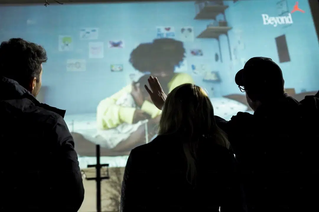 spectators admiring the Nike projection mapping on a building