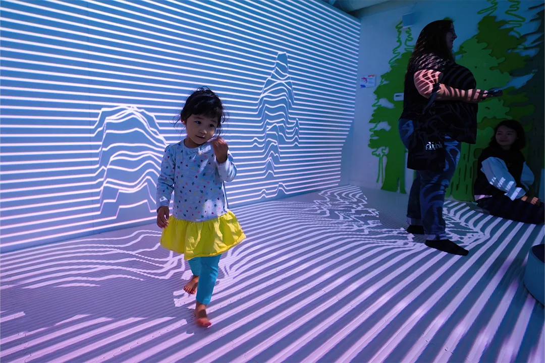 little girl walking through 3D interactive immersive room