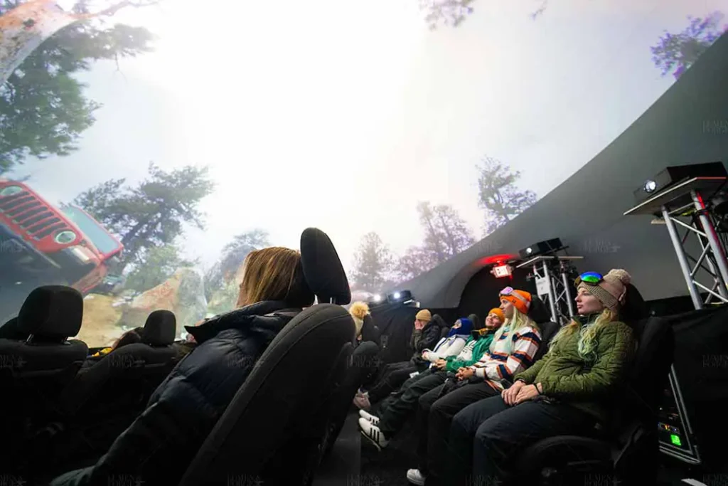 woman seated inside a projection dome